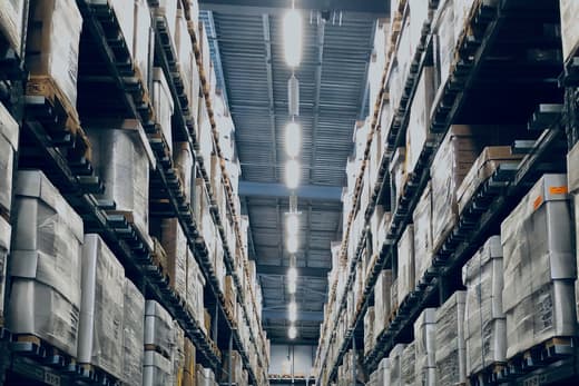 Aisle of racked pallets in a distribution warehouse